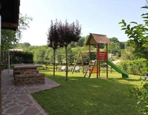 a park with a playground with a slide and a tree at Matxingonea 1 in Urdax