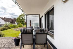 a patio with chairs and a table on a balcony at Ferienwohnung Sonnenschein in Bad Hersfeld