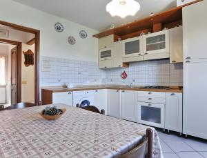 a kitchen with a table with a bowl on it at Appartamento Tramonto in Capoliveri +18 photos