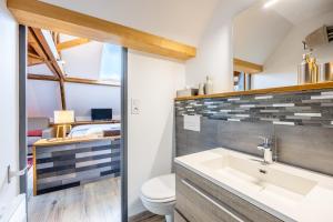 a bathroom with a sink and a toilet at Chambres D'hôtes Le Palmier in Sevremont +68 photos