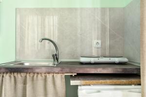 a kitchen counter top with a sink and a sink at Old Boat double studio 1 in Nikiana