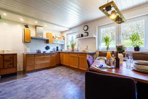 a kitchen with a wooden table and a dining room at s'Lähmes auf der Schwend in Kappelrodeck