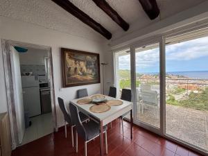a dining room with a table and a view of the ocean at Villa Mediterraneo in Tossa de Mar