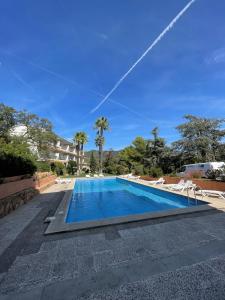 a swimming pool in a villa with palm trees at Villa Mediterraneo in Tossa de Mar