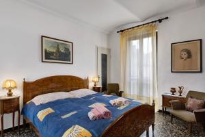a bedroom with a bed with a blue blanket at Casa Dello Zio Birba in Portacomaro