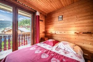 a bedroom with a bed and a large window at La Flèche d'Or in Châtel +291 photos