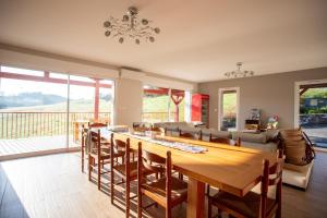 a dining room with a large wooden table and chairs at Chambre - Orchis in Aroue