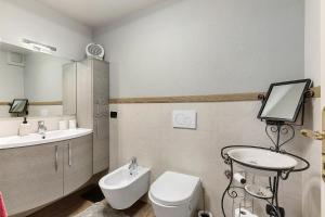 a bathroom with a sink and a toilet and a mirror at Casa Gardenia in Arvier +22 photos