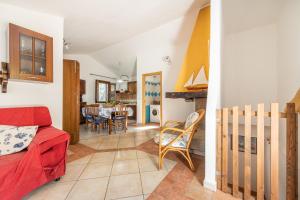 a living room with a red couch and a dining room at Villa Maladroxia in Maladroscia +20 photos