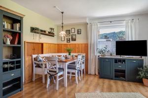 a kitchen and dining room with a table and chairs at Aufblühen in Menzenschwand in St. Blasien