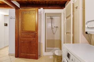 a bathroom with a shower and a wooden door at Le Bourg 61 - Aosta Centro in Aosta +20 photos