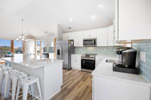 a kitchen with white cabinets and a counter top at 1345 - Amarissa by the Sea in Corolla