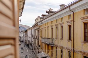 a street in an old town with yellow buildings at Le Bourg 61 - Aosta Centro in Aosta