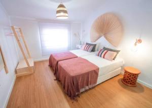 a bedroom with a large bed with a wooden floor at Quinta da Romã in Olhão +33 photos