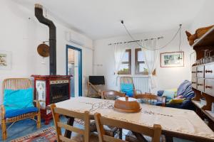 a living room with a table and a fireplace at La Ripa - Appartamento Il Fienile in San Gimignano