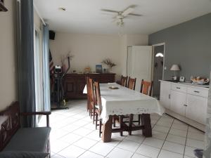 a kitchen and dining room with a table and chairs at Sweet Home - Gujan-Mestras in Gujan-Mestras