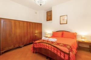 a bedroom with a bed and wooden cabinets at Villa Toscana a Fiesole in Florence