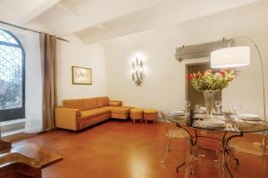 a living room with a table and a couch at Villa Toscana a Fiesole in Florence