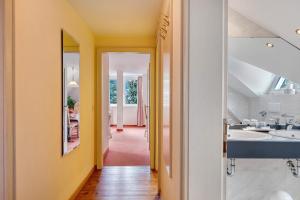 a bathroom with two sinks and a hallway at Ferienhaus Adler Bellevue in Hinterzarten +171 photos