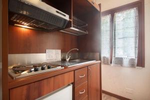 a kitchen with a stove and a sink at Appartamento Bilocale Moneglia 22 in Moneglia