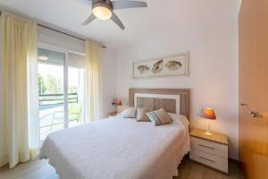 a white bedroom with a bed and a window at Calma Mar in Los Mártires +11 photos