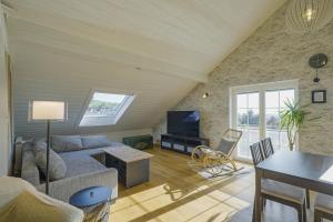 a living room with a couch and a tv at Happy Hugle Haus in Offenburg