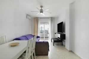 a living room with a couch and a table at Casa En El Centro De Barbate in Barbate