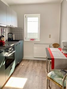 a kitchen with a table and a window in it at Haus Usedom in Kröslin