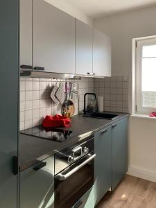 a kitchen with stainless steel appliances and a window at Haus Usedom in Kröslin