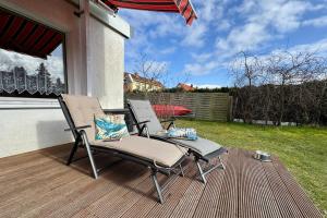 a pair of chairs sitting on a deck at Haus Usedom in Kröslin
