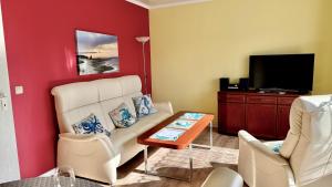 a living room with a couch and a tv at Haus Usedom in Kröslin +7 photos