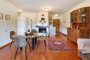 a dining room with a table and chairs and a fireplace at Cima de' Piazzi Apartment 1 in Valdidentro
