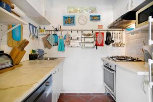 a kitchen with white walls and a counter top at Casa do Campo Dornes Um in Paio Mendes