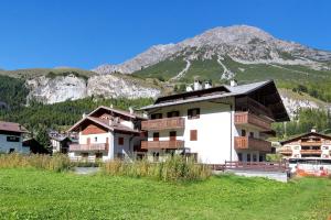 a group of buildings in front of a mountain at Cima de' Piazzi Apartment 1 in Valdidentro