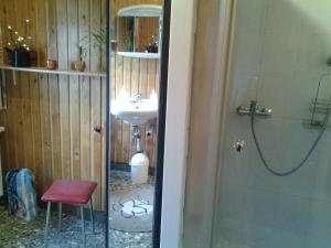 a bathroom with a sink and a shower and a red stool at Ferienhaus Werner in Neustadt +26 photos