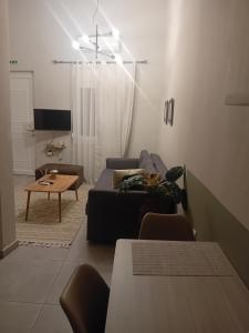 a living room with a couch and a table at Christi Iuxury Apartment in Preveza