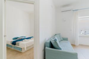 a bedroom with a mirror and a bed and a chair at Casa Anastasia in Otranto