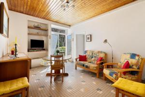 a living room with a couch and a table at Maison Pêcheur, jardin et plage -1 in Pornic