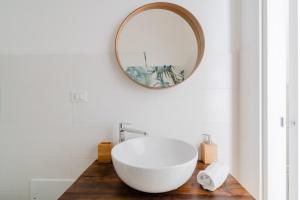 a bathroom with a white sink and a mirror at Casa Anastasia in Otranto +17 photos