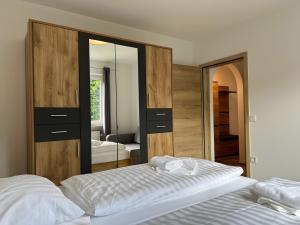 a bedroom with a bed and a large mirror at Fewo A6 mit Sauna und Fitnessraum in Oberaudorf