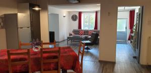 a kitchen and living room with a table and a couch at Gîte De La Verdurette in Pettonville