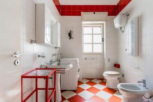 a bathroom with a sink and a toilet and a window at Villa Cinzia in Torre Lapillo +15 photos