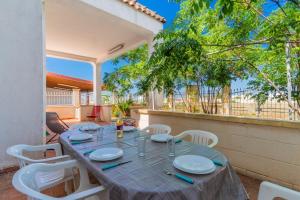 a table and chairs on the patio of a house at Villa Cinzia in Torre Lapillo