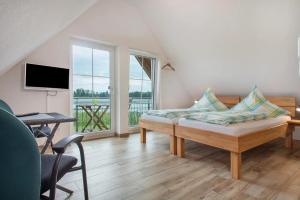 a living room with a couch and a large window at Waldsuite in Friedrichshafen