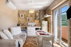 a kitchen and living room with a table and chairs at Casa Virginia - Vigna in Orco Feglino