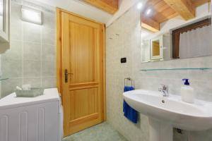 a bathroom with a sink and a mirror at La Maison de Marguerite in Saint Vincent +22 photos