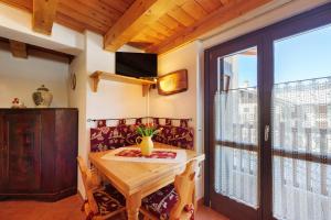 a dining room with a table and a window at La Maison de Marguerite in Saint Vincent