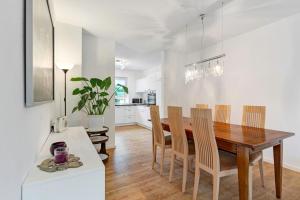 a kitchen and dining room with a wooden table and chairs at Haus 15 in Offenburg