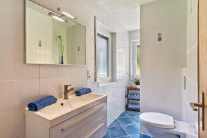 a white bathroom with a sink and a toilet at Heidi Kimmig in Bad Griesbach +18 photos