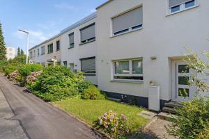 an empty street in front of a white building at Haus 15 in Offenburg